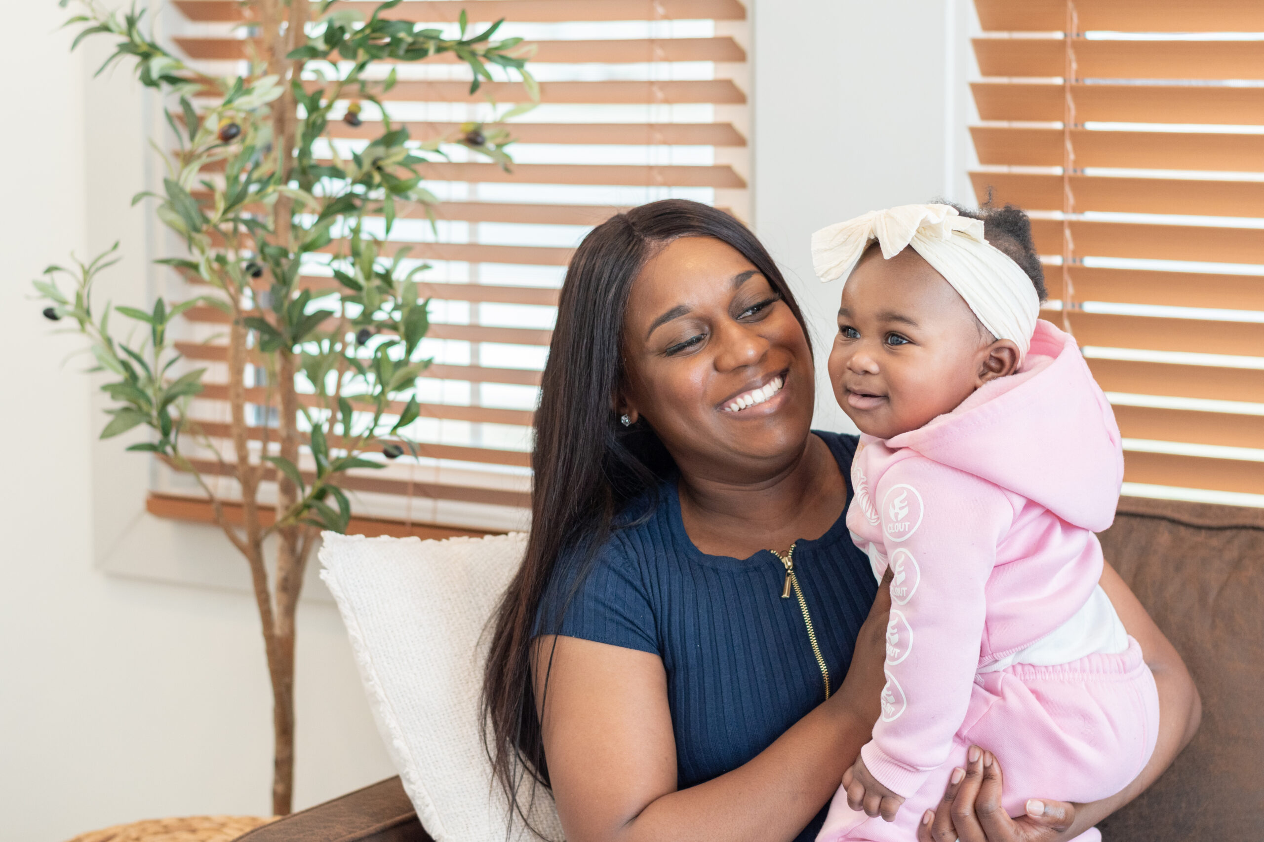 woman and little girl in pink hoodie sitting together