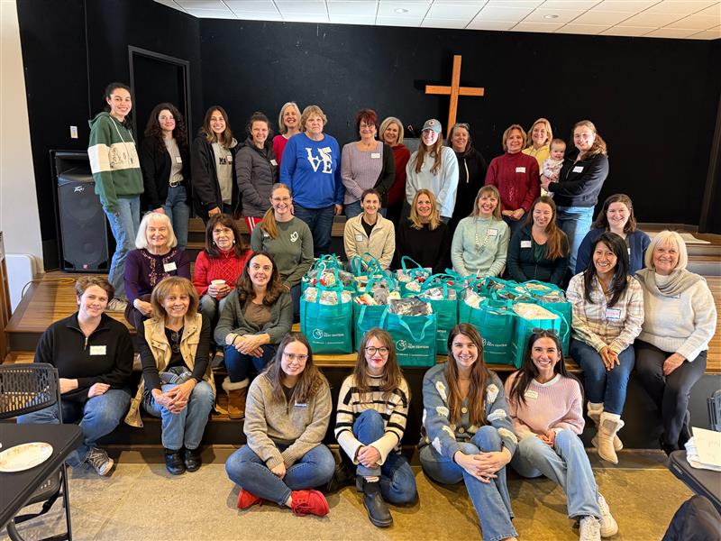 Group of women with donation bags in a church building