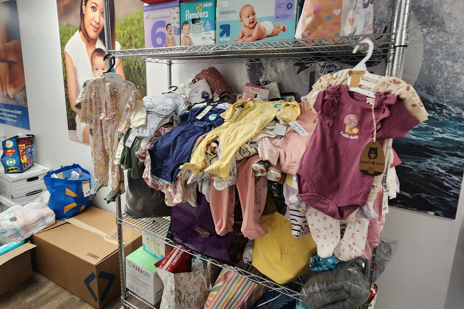 Baby closet with clothes, diapers, and bags for gifts