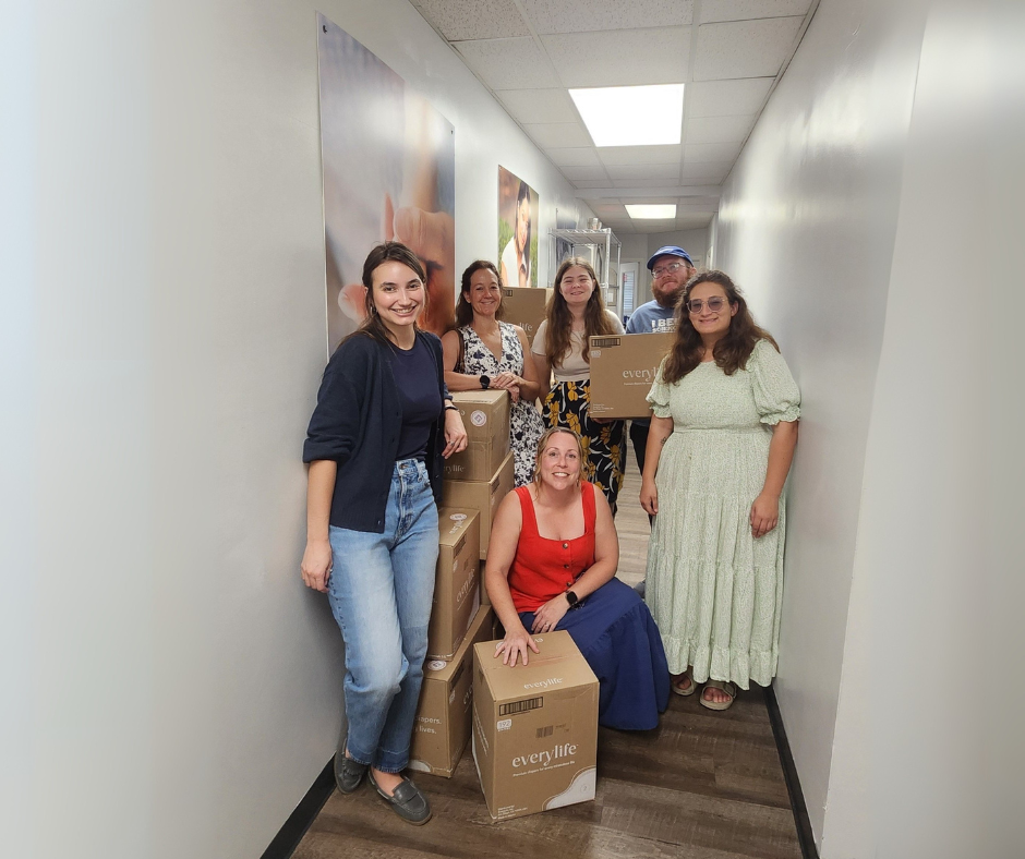 Group of women with cardboard boxes in a hallway