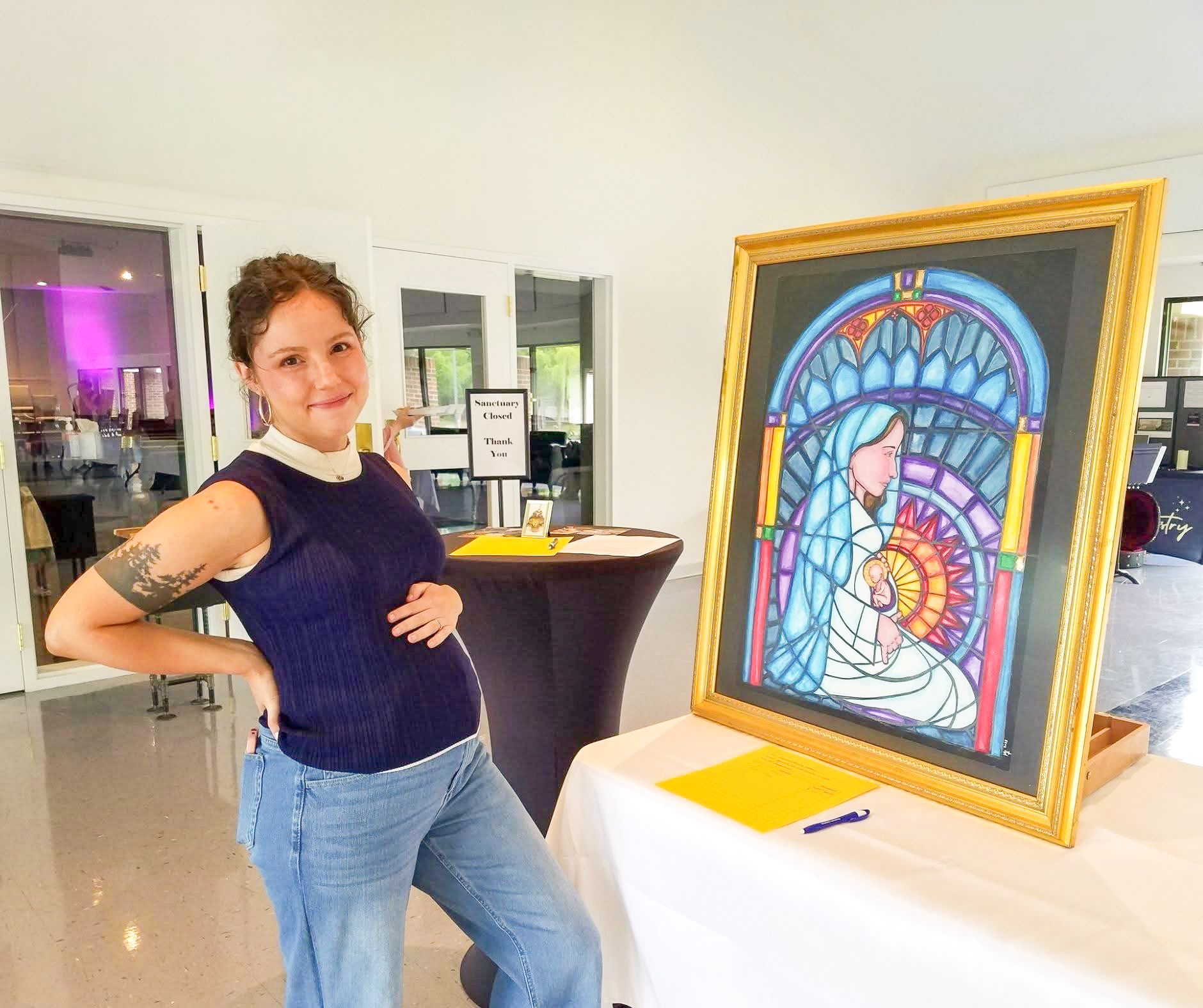 woman next to a mosaic painting